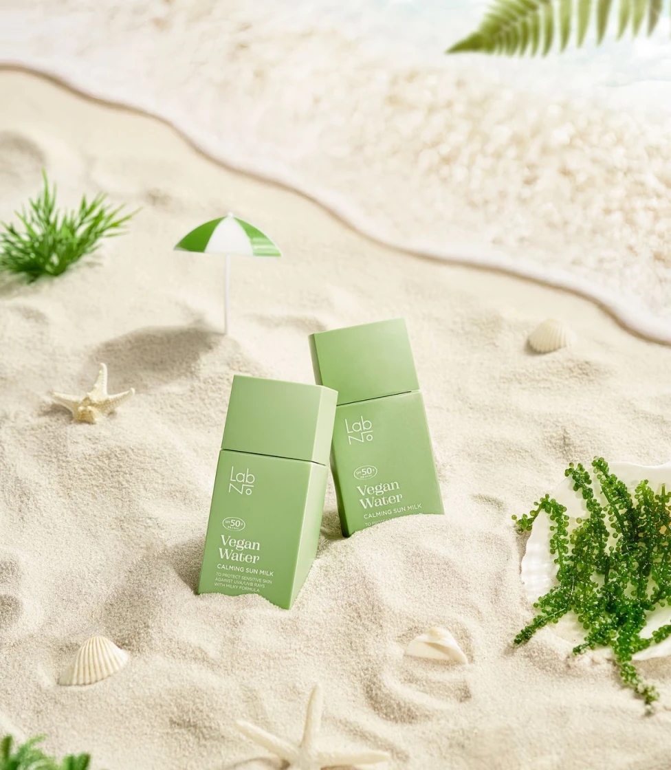 LumiPure Cream tubes on sand
